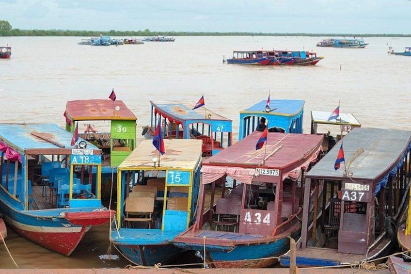 A collection of colorful boats docked at a river port. 4