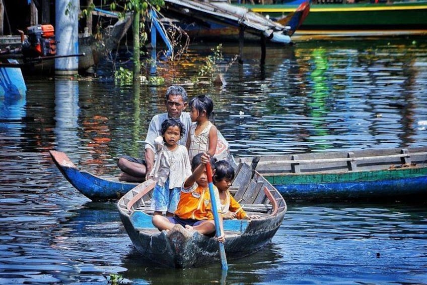 A group of people in a small boat on a river. 1