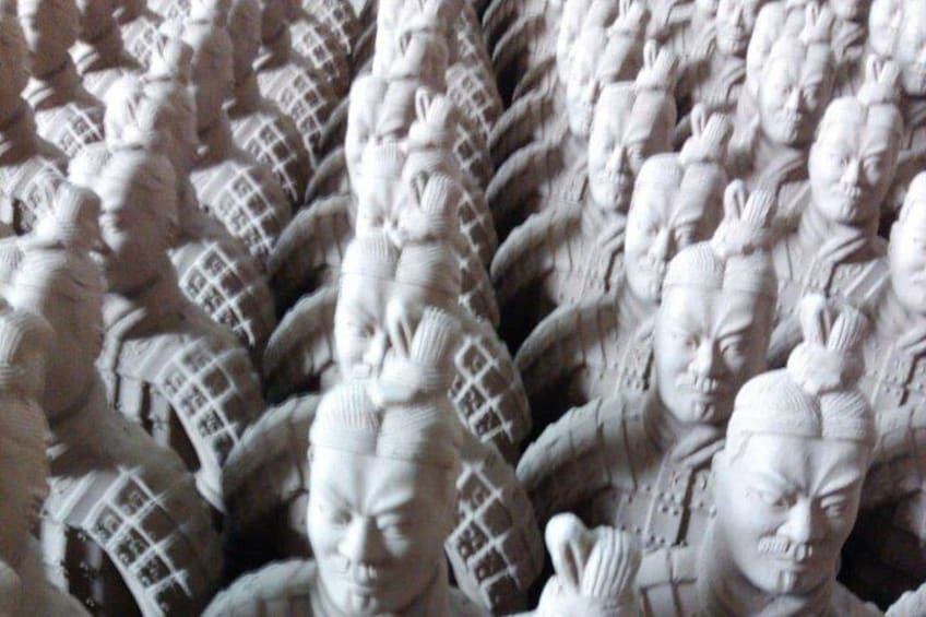 A close-up of a textured surface with repetitive patterns, possibly a sculpture or relief. 5