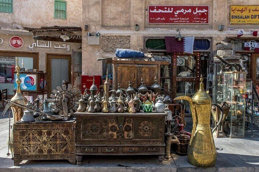 A street market with antique metalware and pottery. 3
