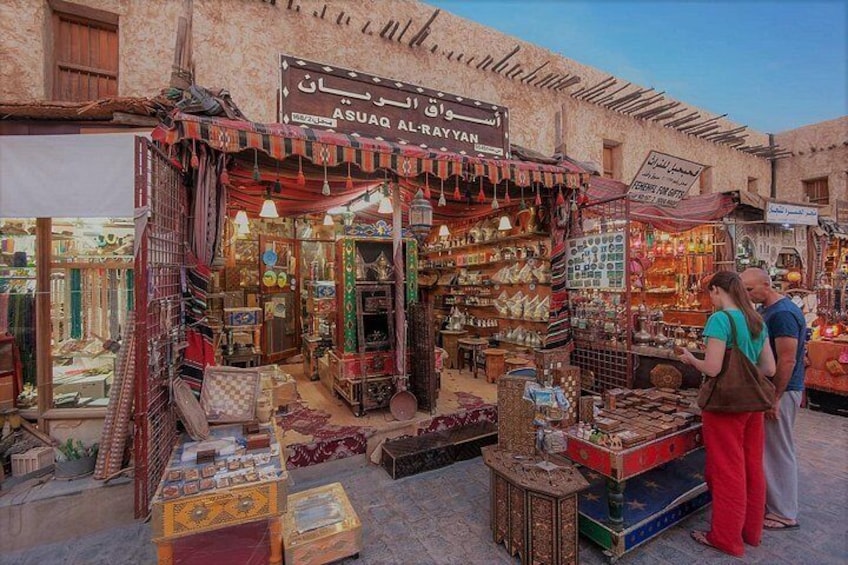 A bustling market stall with various textiles and decorative items. 4