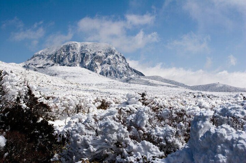 A snow-covered mountain landscape with a clear sky. 4
