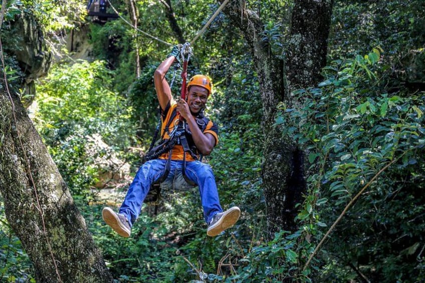 A person zip-lining through a forested area. 2