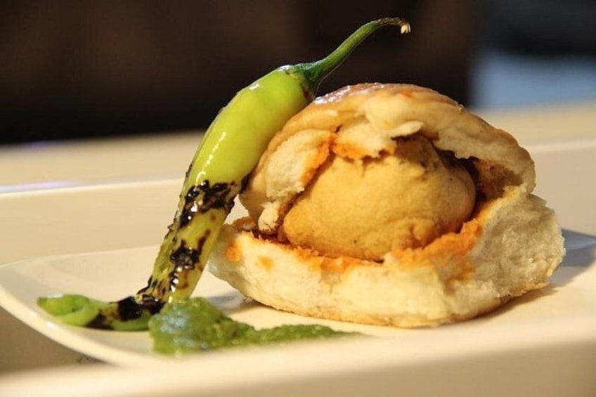 A dessert with a green chili on a white plate. 1