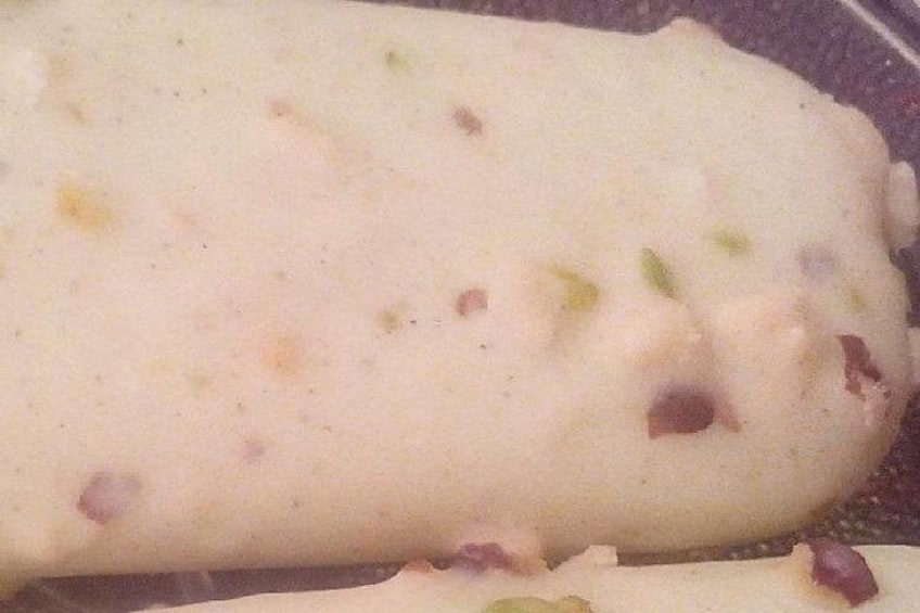 A loaf of bread with visible ingredients like green herbs and red bits, possibly bacon or ham. 3