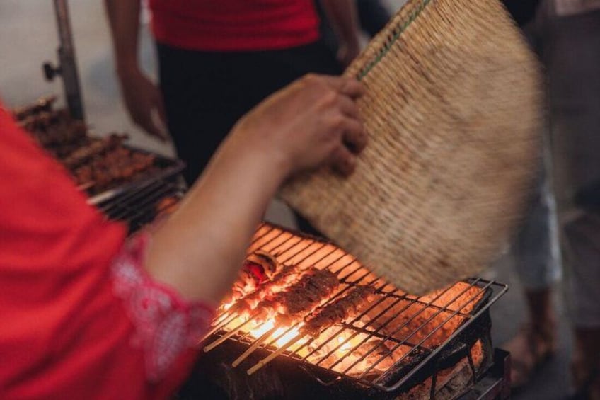 A person grilling food on a barbecue. 4