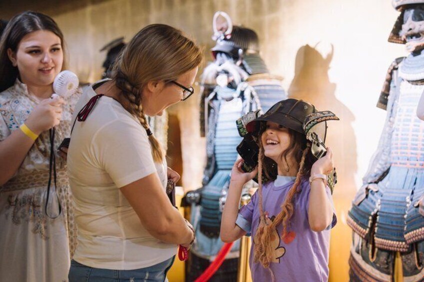 A person in a white shirt and another in a purple shirt with a pirate hat, both in a historical reenactment setting. 4