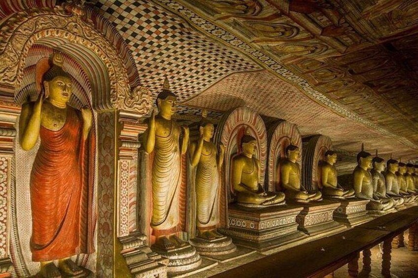 A row of golden Buddha statues in a temple with intricate ceiling designs. 2