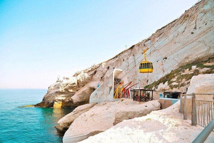 A cable car system, rocky cliffs, and a coastal area. 1