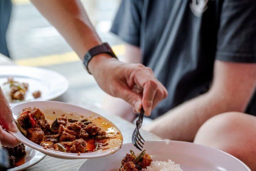 A person eating a meal with a fork. 2