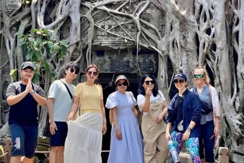 A fun group photo at Ta Prohm temple on Angkor Wat Sunrise tour 4
