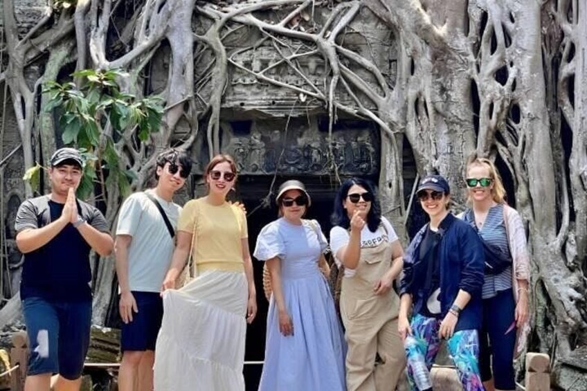 A fun group photo at Ta Prohm temple on Angkor Wat Sunrise tour 4