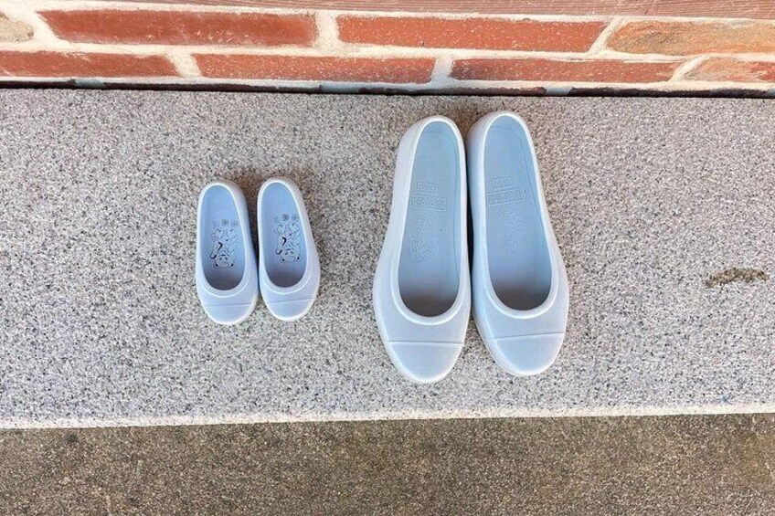 A pair of shoes on a concrete surface. 4