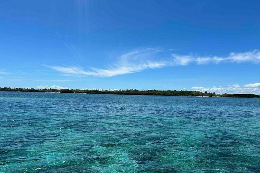 A clear blue sea with a distant shoreline. 2