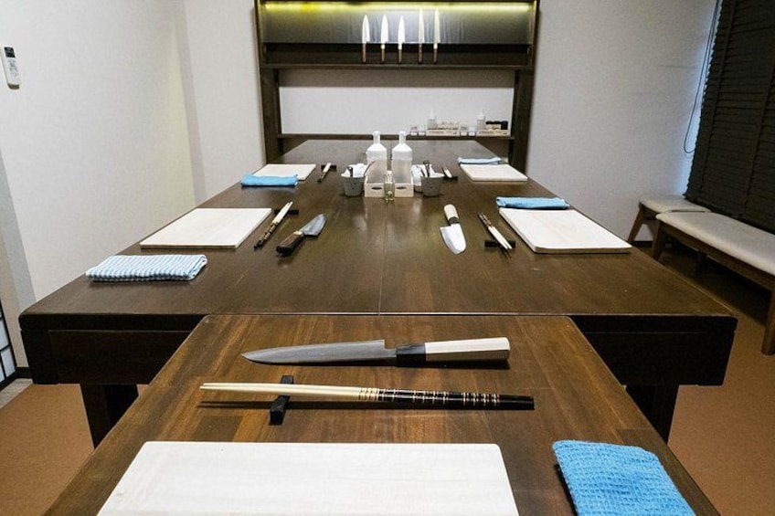 A conference table with various office supplies and a large knife. 2