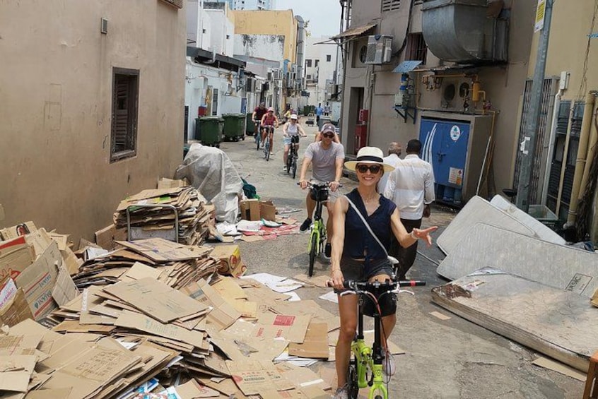 A narrow street with cardboard boxes and construction materials. 3