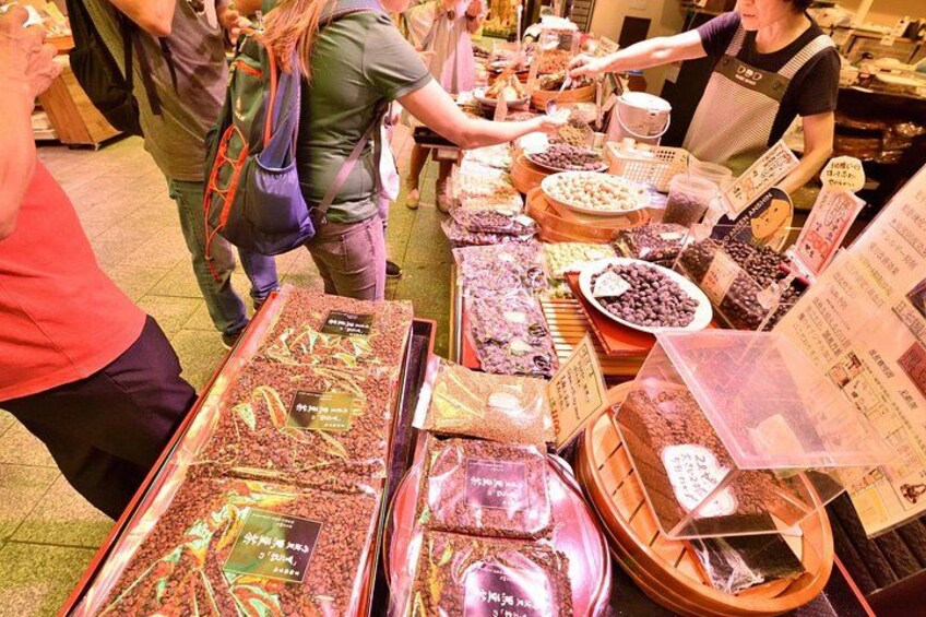 A food stall with various food items displayed in trays and baskets. 2