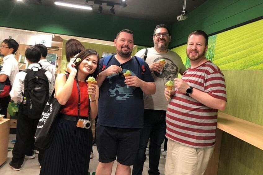 A group of people in a food court with green walls and wooden counters. 4