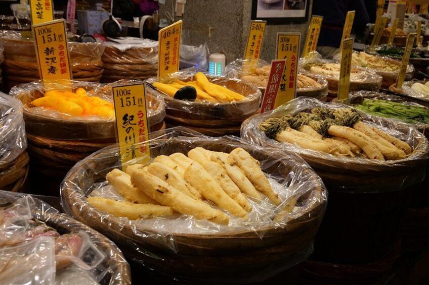 Various food items in baskets with price tags. 4