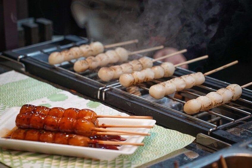 Skewers of food being grilled on a barbecue. 1
