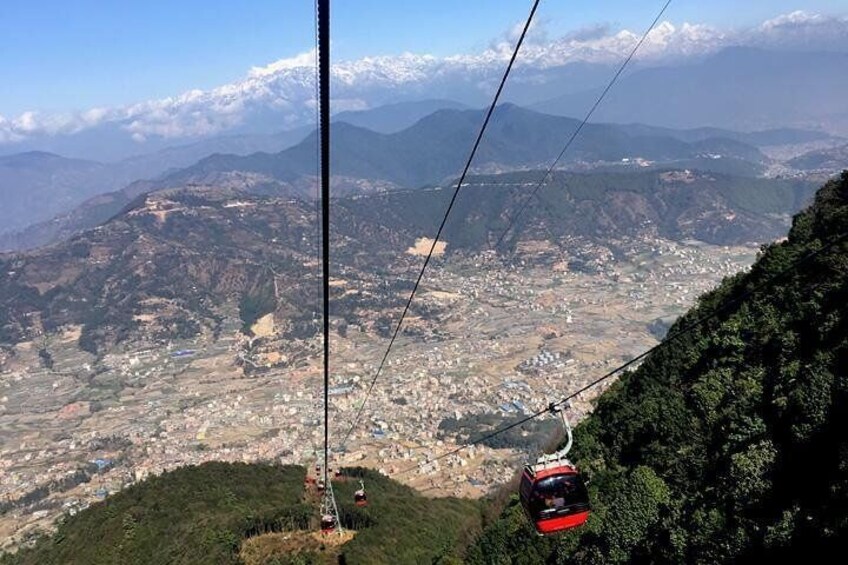 A cable car on a mountain with a view of a valley below. 2