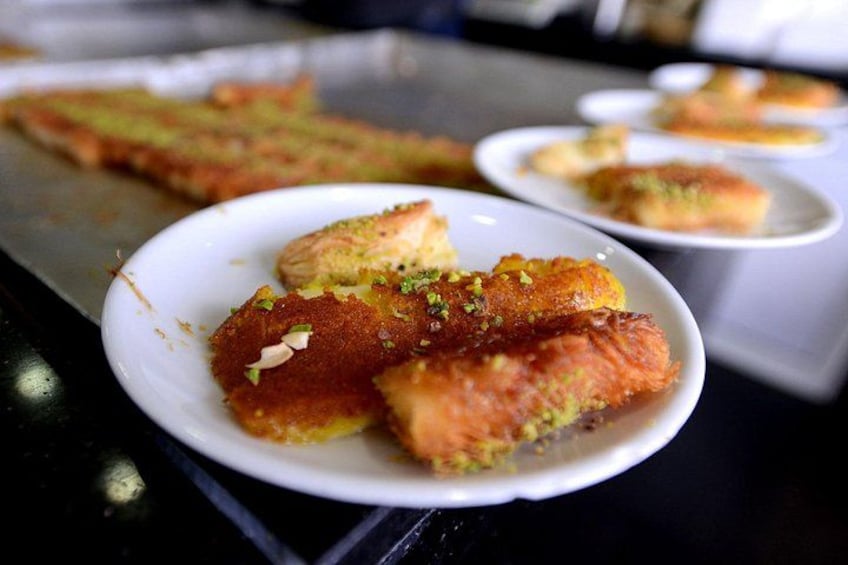 A plate of baklava with pistachios. 2