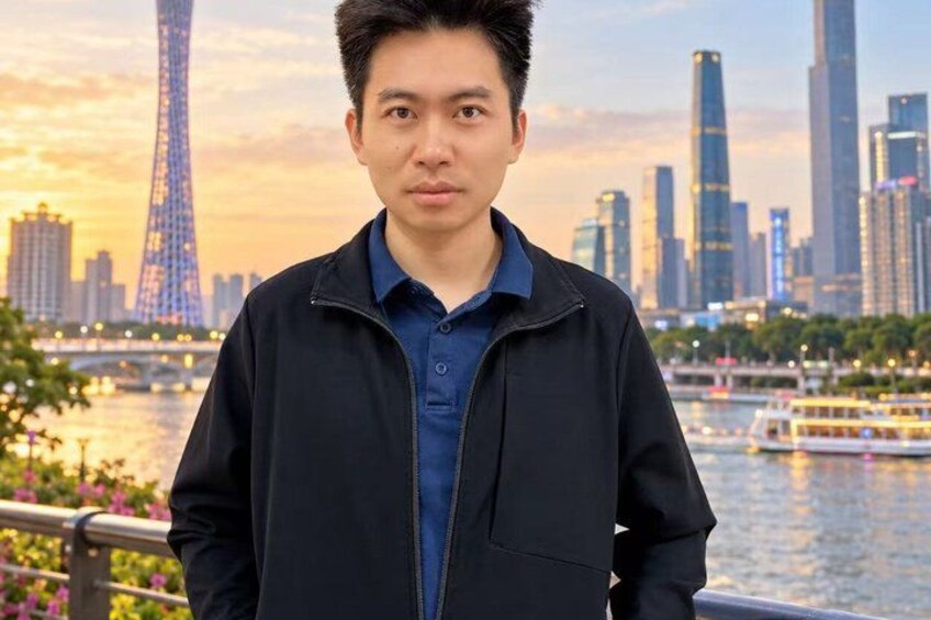 A person standing with a city skyline and a river in the background. 2