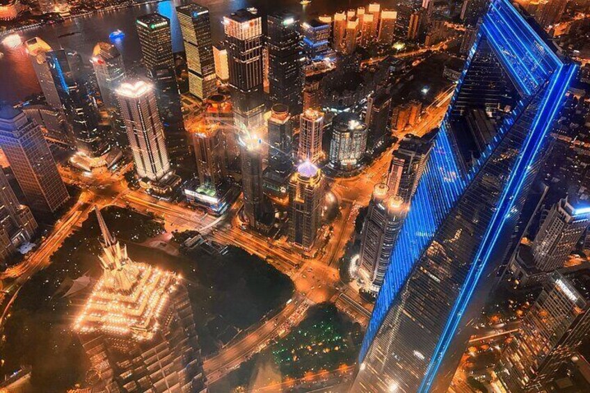 A nighttime cityscape with illuminated skyscrapers and a river. 2