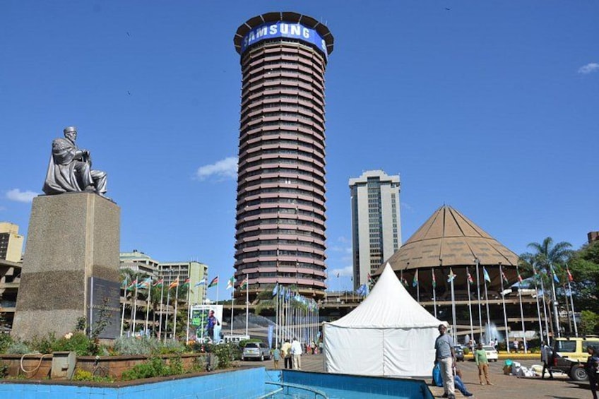 A statue, a tall cylindrical building with a Samsung logo, and a tent. 3