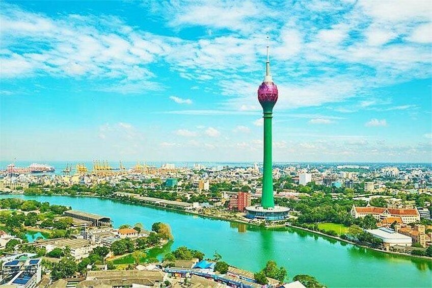 A cityscape with a prominent tower, a river, and surrounding greenery. 2