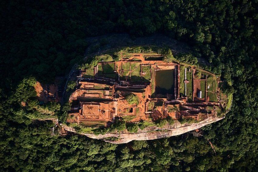 An ancient ruin complex surrounded by dense forest. 3