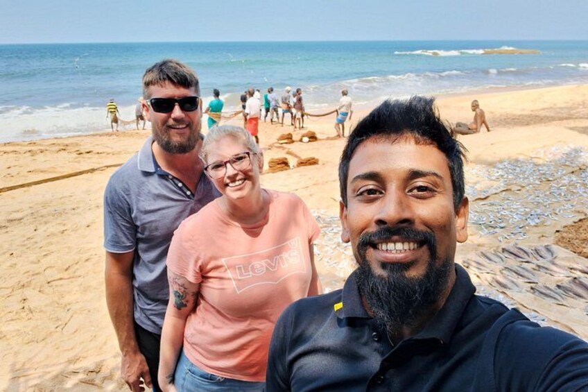 A beach with people walking and standing on the sand, the ocean in the background, and a clear sky. 4