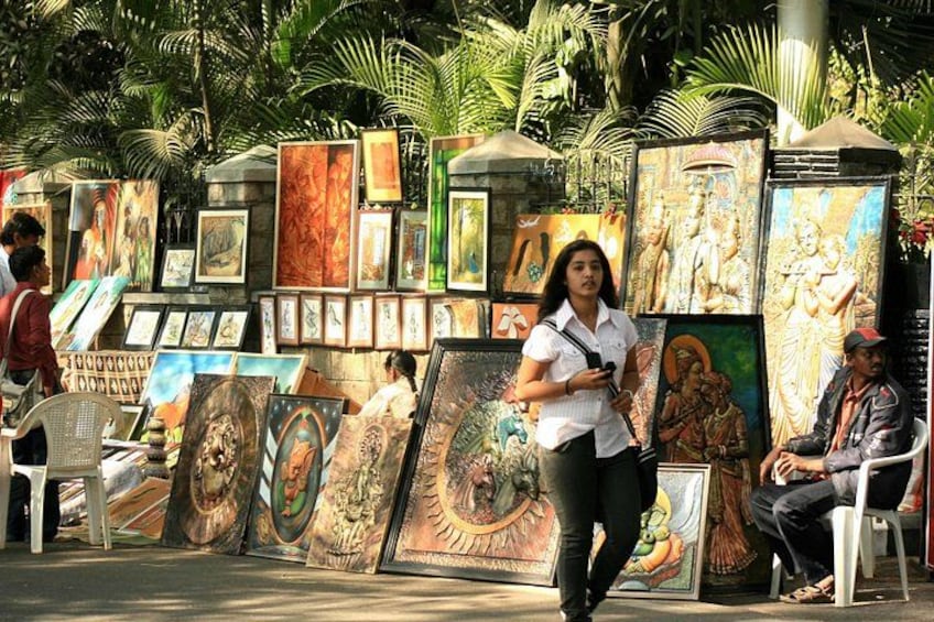 A street art display with various paintings and sculptures. 2