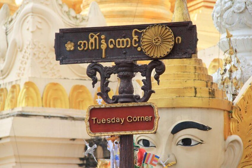 A sign with 'Tuesday Corner' and a decorative element. 4