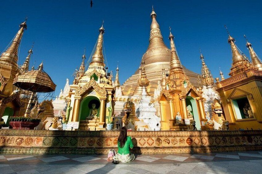 A golden pagoda with multiple tiers and a green entrance. 5