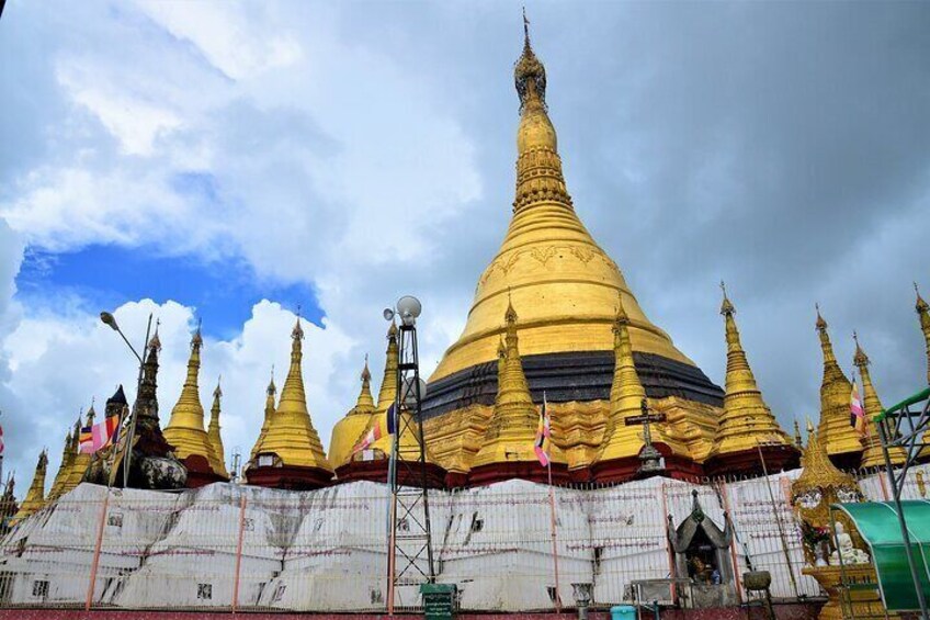 A row of golden pagodas under a cloudy sky. 3