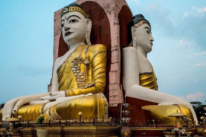 Two large golden Buddha statues seated side by side. 1
