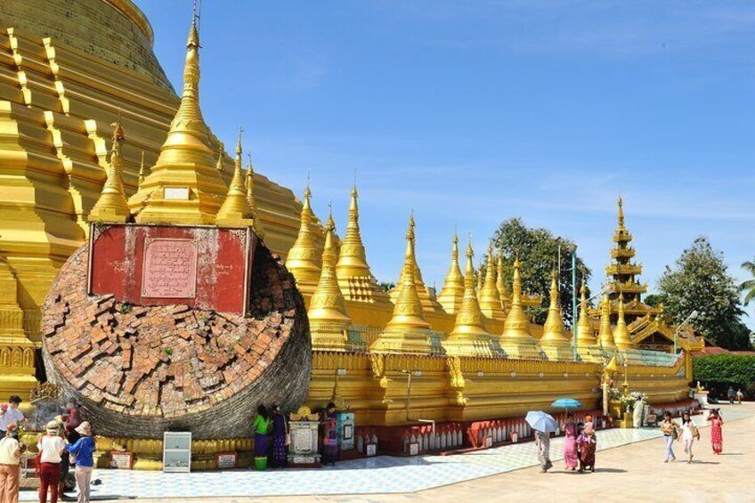 A golden pagoda with multiple tiers and a large circular structure in the foreground. 3