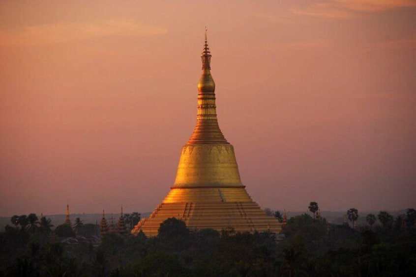 A golden pagoda with a pointed top, surrounded by trees and a sunset sky. 2
