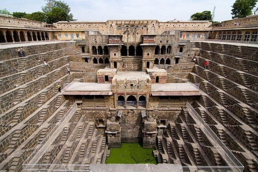 A large, ancient stone structure with multiple levels and a central courtyard. 3