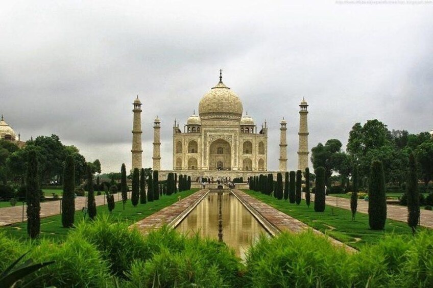 The Taj Mahal with a reflecting pool, minarets, and a symmetrical garden layout. 5