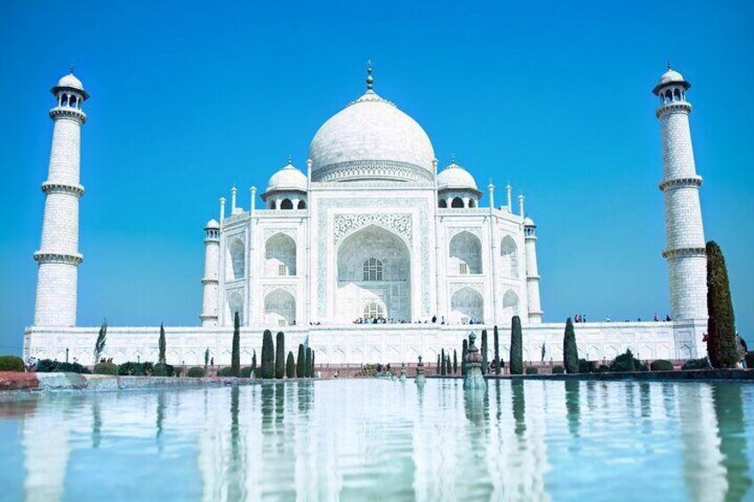 The Taj Mahal with its four minarets and reflection in the water. 4