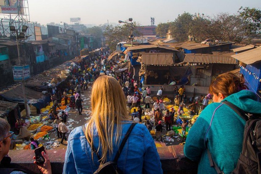 A crowded market with people and stalls. 4