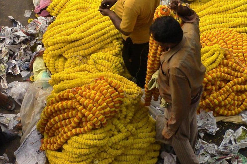 A person arranging large bundles of yellow flowers. 1