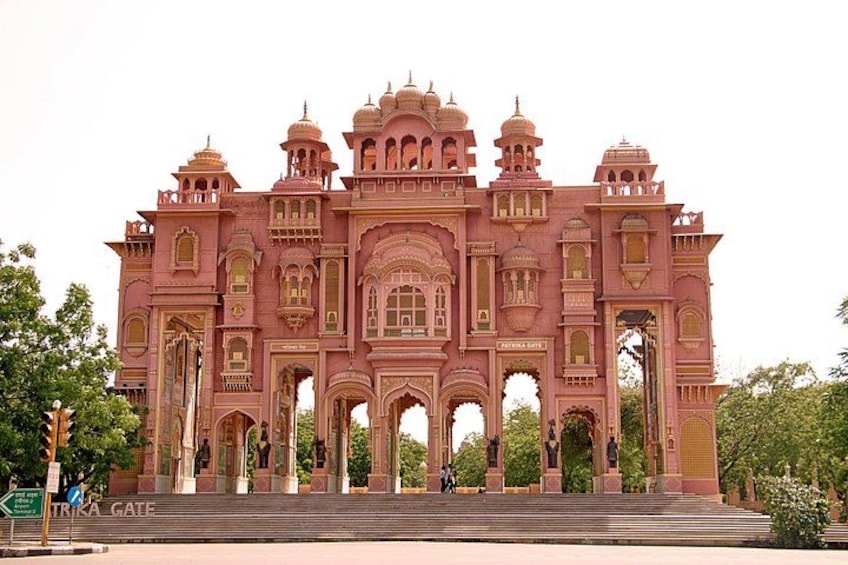 A large, ornate building with multiple arches and domes, a prominent entrance, and steps leading up to it. 5