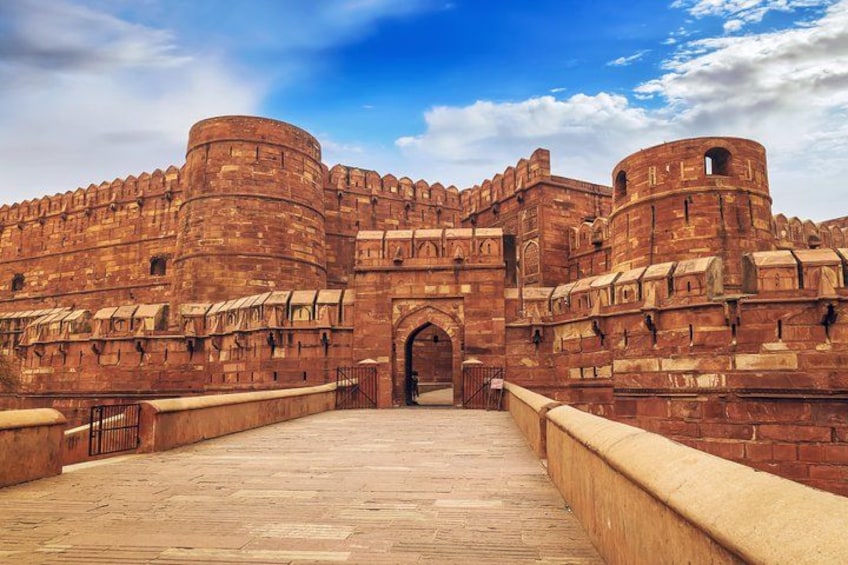 A large, historic fort with red brick walls and a central archway. 3