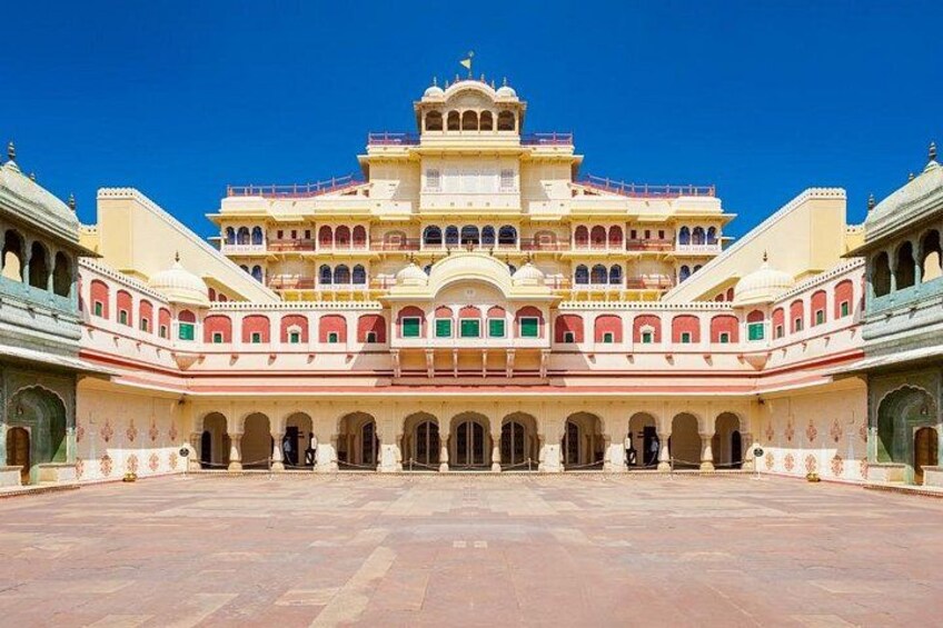 A large, ornate building with multiple arches and domes, surrounded by a courtyard. 5