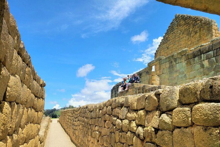 Ancient stone walls, a clear sky, and a pathway leading into the distance. 3