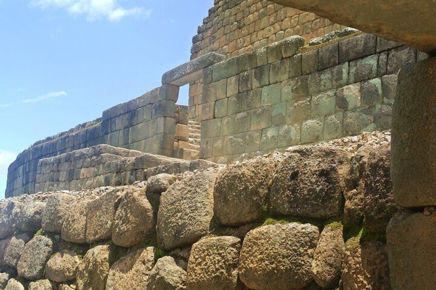 Ancient stone ruins with large, weathered blocks and a partially intact wall structure. 3
