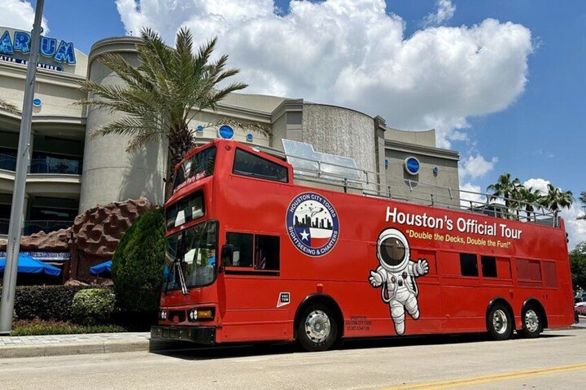 A red double-decker bus with 'Houston's Official Tour' and an astronaut graphic. 4